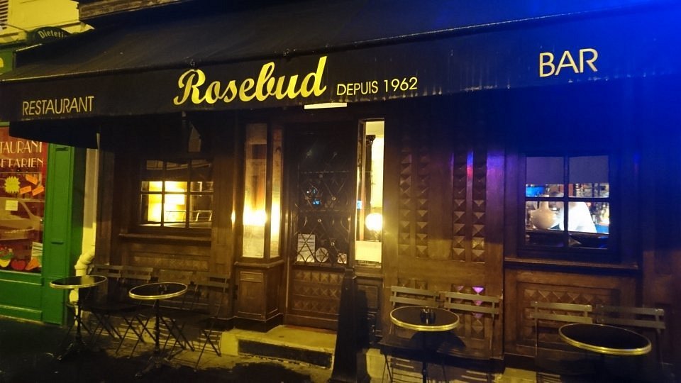 Exterior of a restaurant in Rosebud, Montparnasse, Paris, featuring a sign that reads "Rosebud."