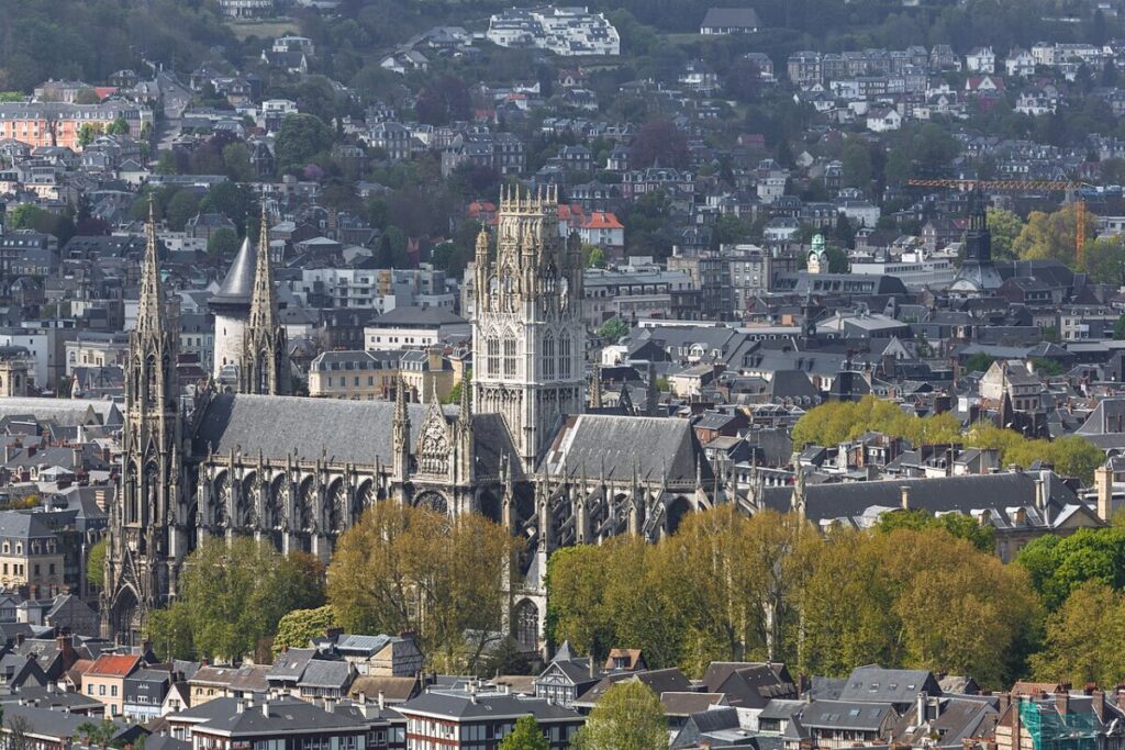 Panoramic view of Rouen, France, showcasing a skyline filled with numerous buildings in a bustling urban environment.