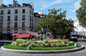 Fountain and establishments at Rue Mouffetard in Paris, France