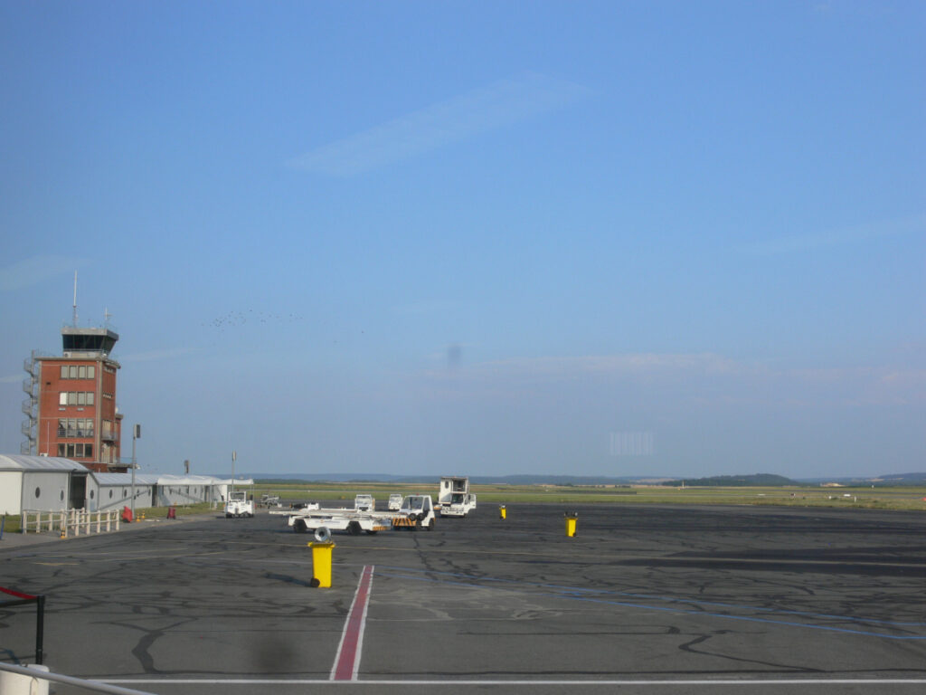 Vibrant blue sky stretches over the runway at Paris Beauvais Airport in Paris, France.