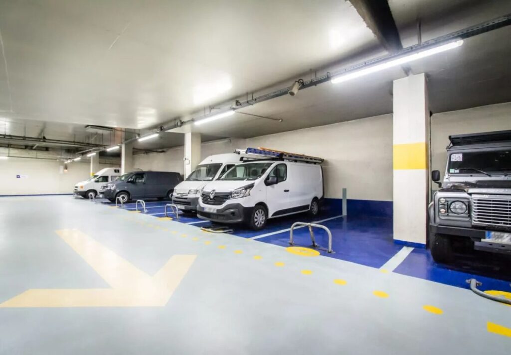 Parking garage at Saeme Porte Dorléans with several vans parked in designated spaces.