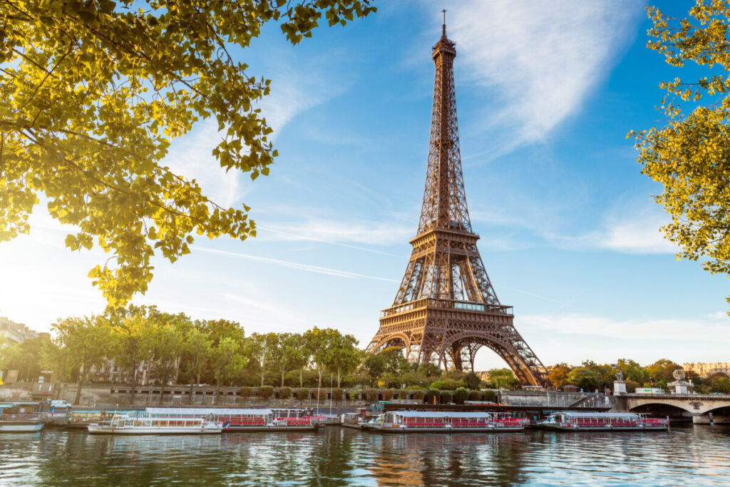 Boats in Seine river with the view of Eiffel Tower in Paris, France