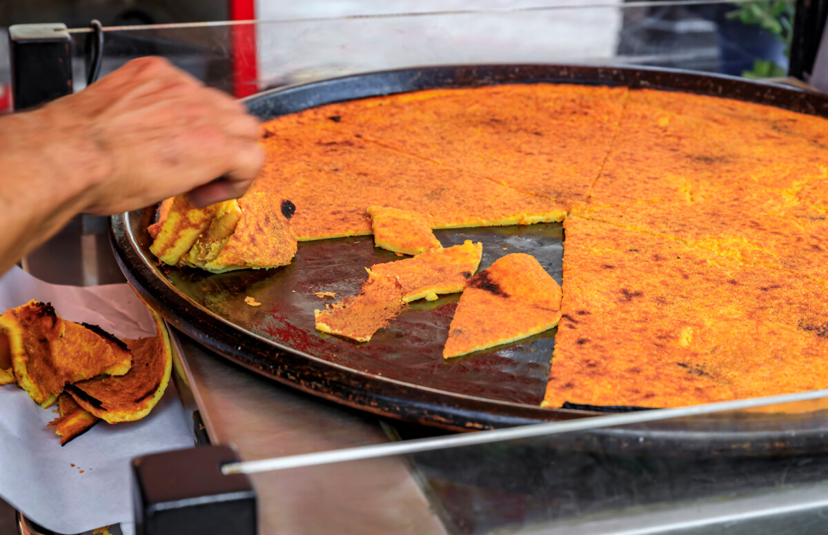 Socca, chickpea pancake cooked at a farmers market in Old Town Nice, France