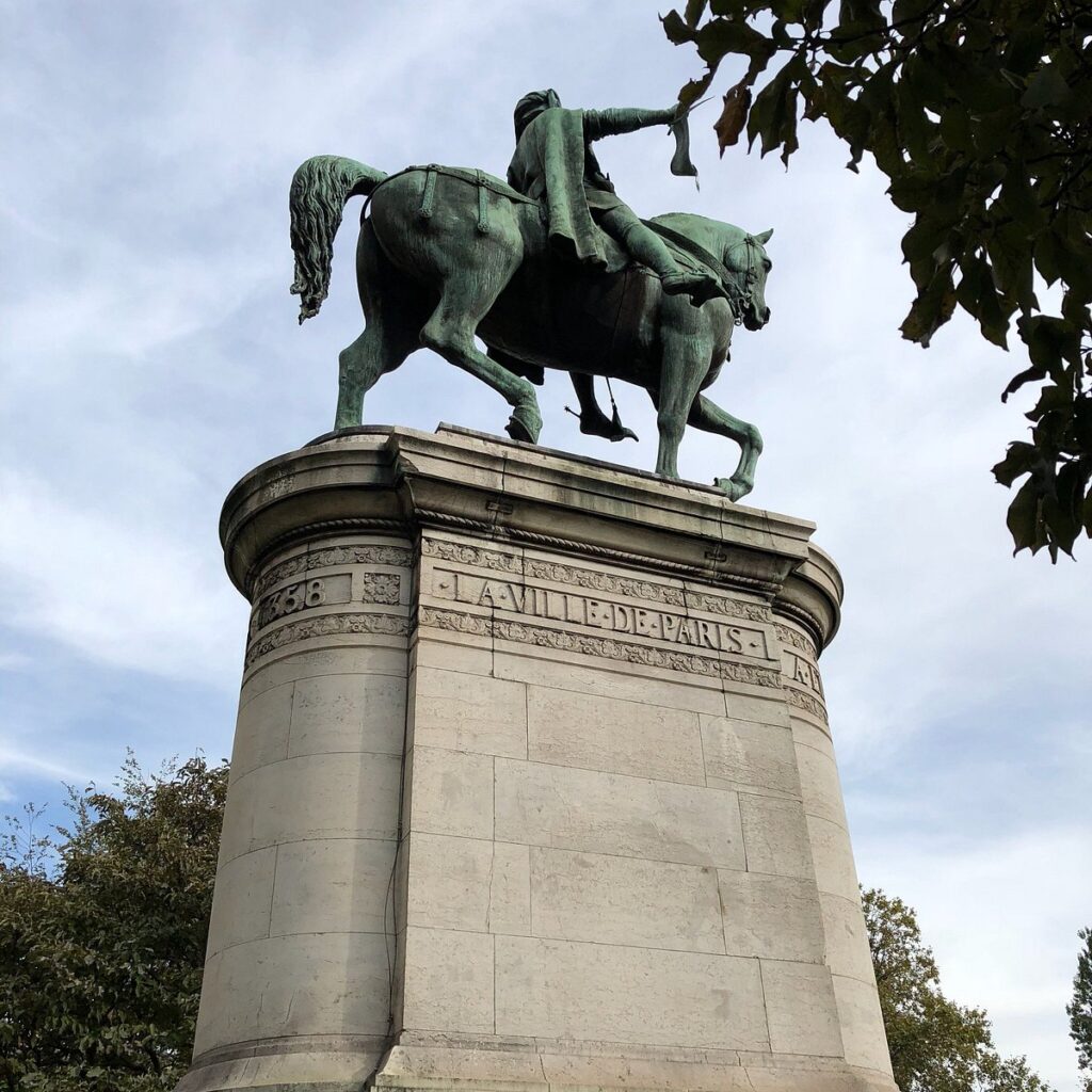 Conservation team working on the statue of Étienne Marcel, with scaffolding around the monument and tools for restoration visible.