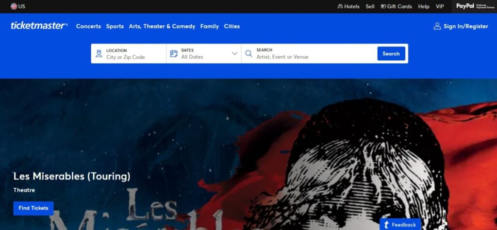 Ticketmaster website homepage featuring a promotional banner for "Les Miserables (Touring)." It shows the iconic image of a young girl with a flag, set against a blue and red background. The tone is dramatic and theatrical. Options to search events and locations are visible at the top.