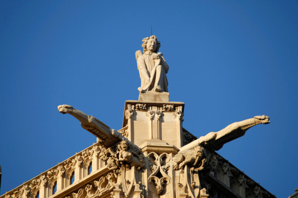 Exterior sculpture and statue on top of the Tour Saint-Jacques Paris and skyline of Paris, France