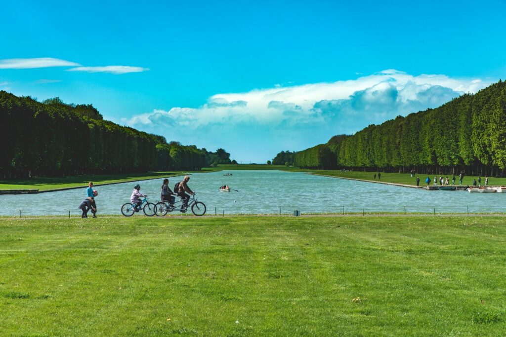 Tourists biking beside the lake in Versailles, France