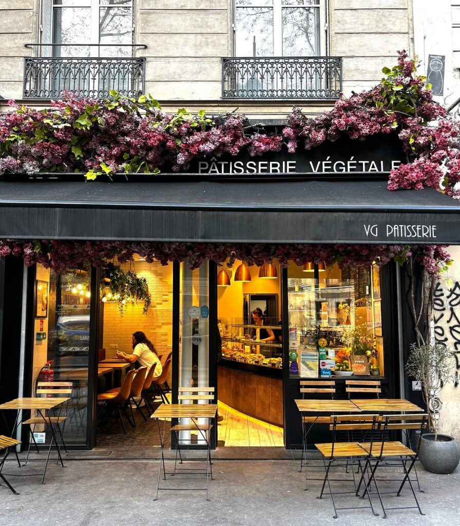 Outdoor seating area at VG Pâtisserie in Paris, featuring tables and chairs under a clear sky.